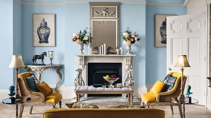 A traditional living room with light blue wall paint decor and framed wall art