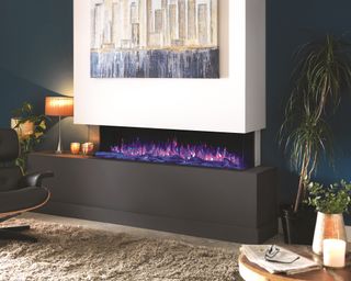 Modern fireplace by Solution Fires with purple pink ember effect with black leather chair, white wall art - Specification: SLE150 Panoramic_SRP UK £1749