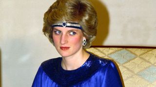 TOKYO, JAPAN - MAY 12: Diana, Princess Of Wales At A Dinner Hosted By Emperor Hirohito In Japan. She Is Wearing A Pleated Royal Blue Evening Dress Designed By Fashion Designer Yuki And A Sapphire And Diamond Headband Made From Jewels Which She Had Reset From The Saudi Suite Converting The Watch Into A Choker To Wear On Her Forehead.