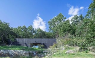 The exterior pine facade of BCHO Architects' Tilt Roof House