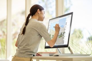 An artist using a Microsoft Surface Studio 2+