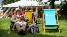 An attendee relaxes at the 2024 Hay Festival in Hay-on-Wye, Wales