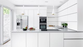 White kitchen with patio doors to highlight a kitchen design mistake to avoid with white