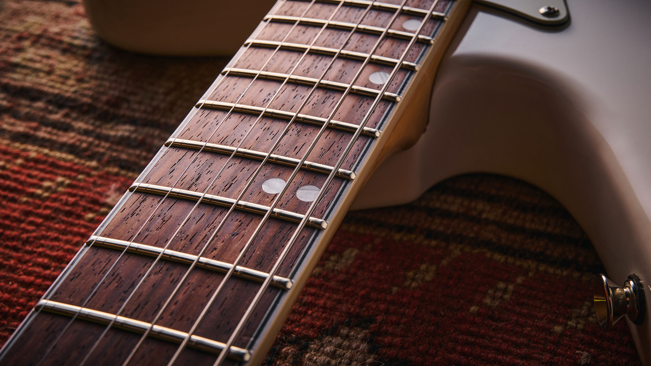 Vintage REVO Astrostar: the retro-inspired electric has three single-coils, a white finish with cream pickguard and is photographed in close-up.