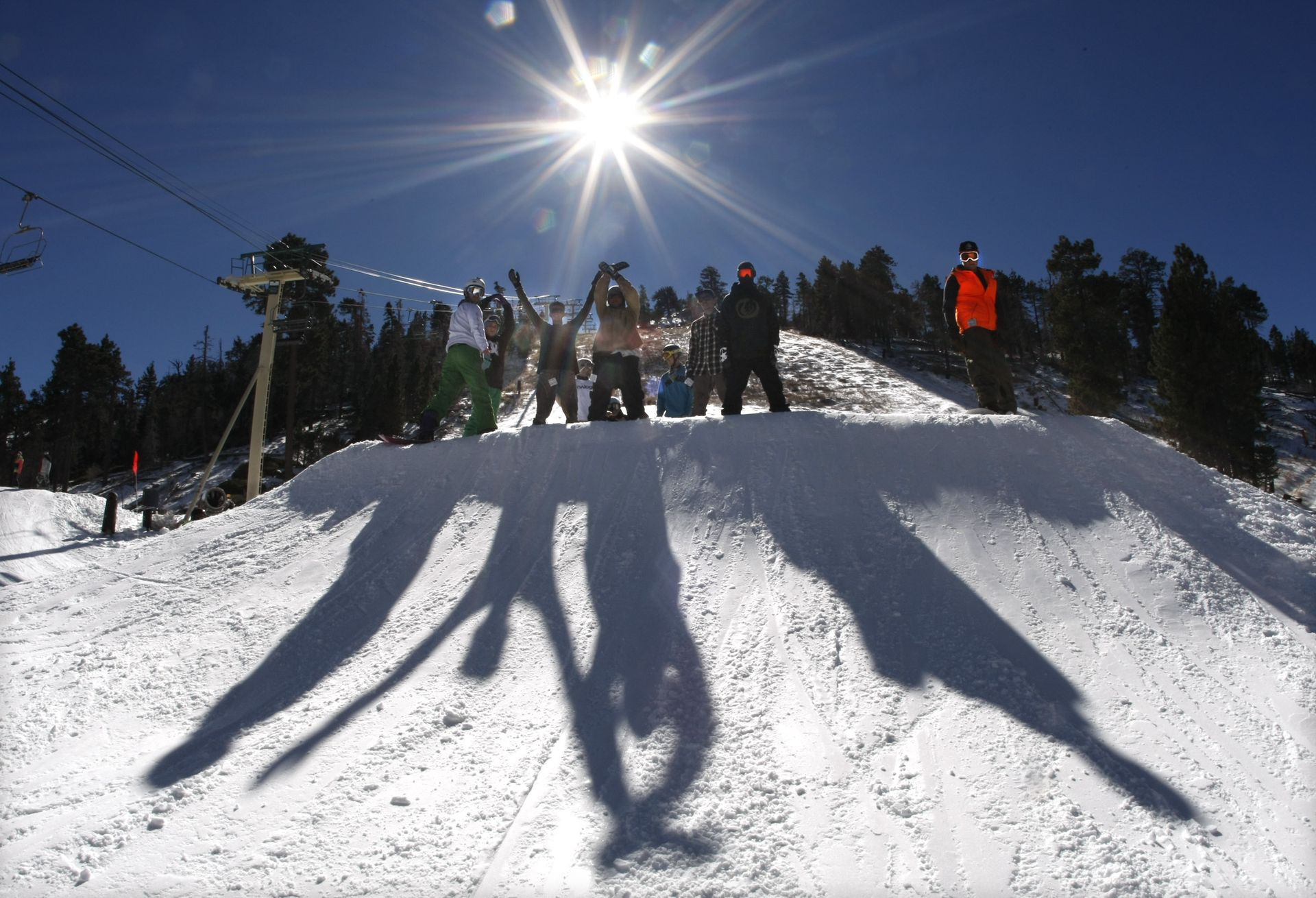 Snowboarders pose for a photo at Bear Mountain Ski Resort in California.