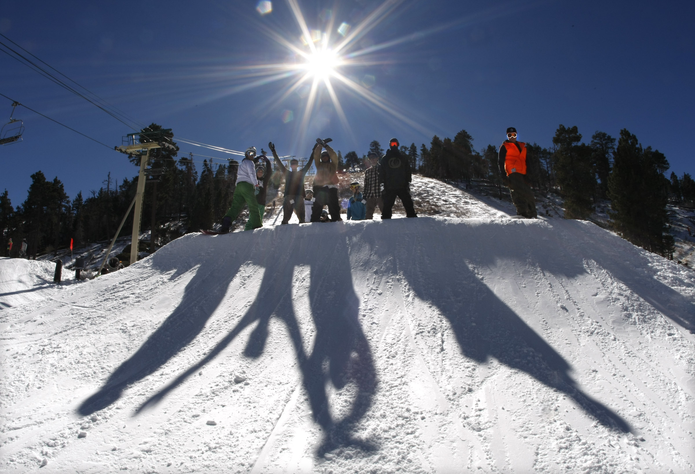 Snowboarders pose for a photo at Bear Mountain Ski Resort in California.