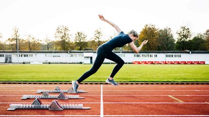 A woman sprints out of the starting blocks