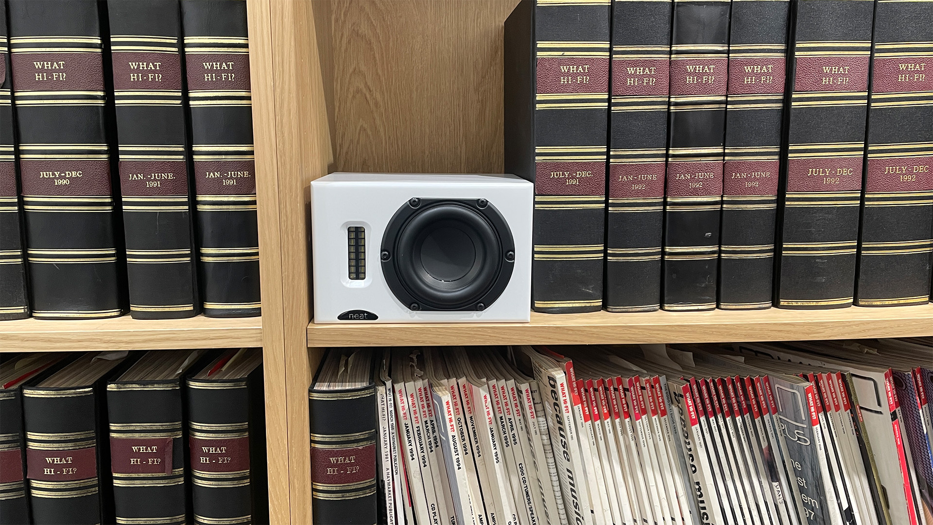 Neat Iota II speaker placed inside a bookshelf