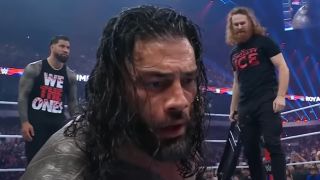 Sami Zayn standing with a chair after hitting Roman Reigns at the 2023 Royal Rumble
