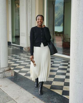 STYLISH CARDIGAN OUTFITS FOR AUTUMN 2024: Taffy wears a black cardigan and pleated midi skirt