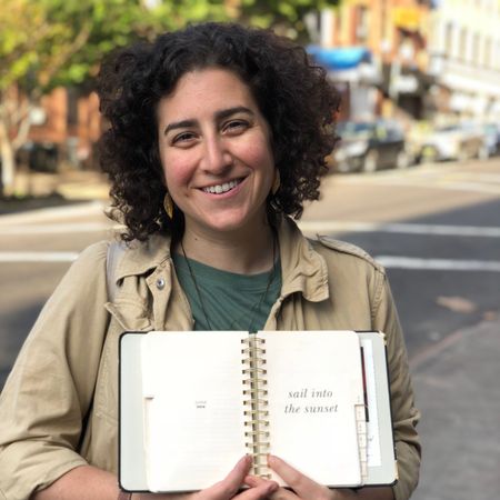 Happy, Street fashion, Publication, Khaki, Jheri curl, Book, Laugh, Necklace, Ringlet, Reading, 