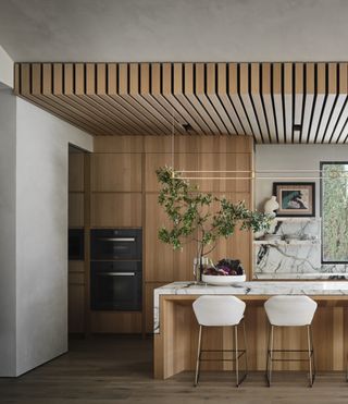 A kitchen with cabinets that go all the way to the ceiling