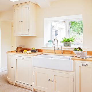 kitchen area with white wall and wooden worktop