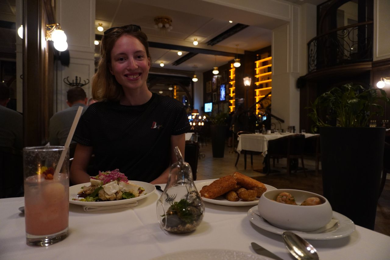 Image shows Anna wearing the Cafe du Cycliste jersey off the bike
