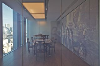 View through glass at dining room with tables and chairs