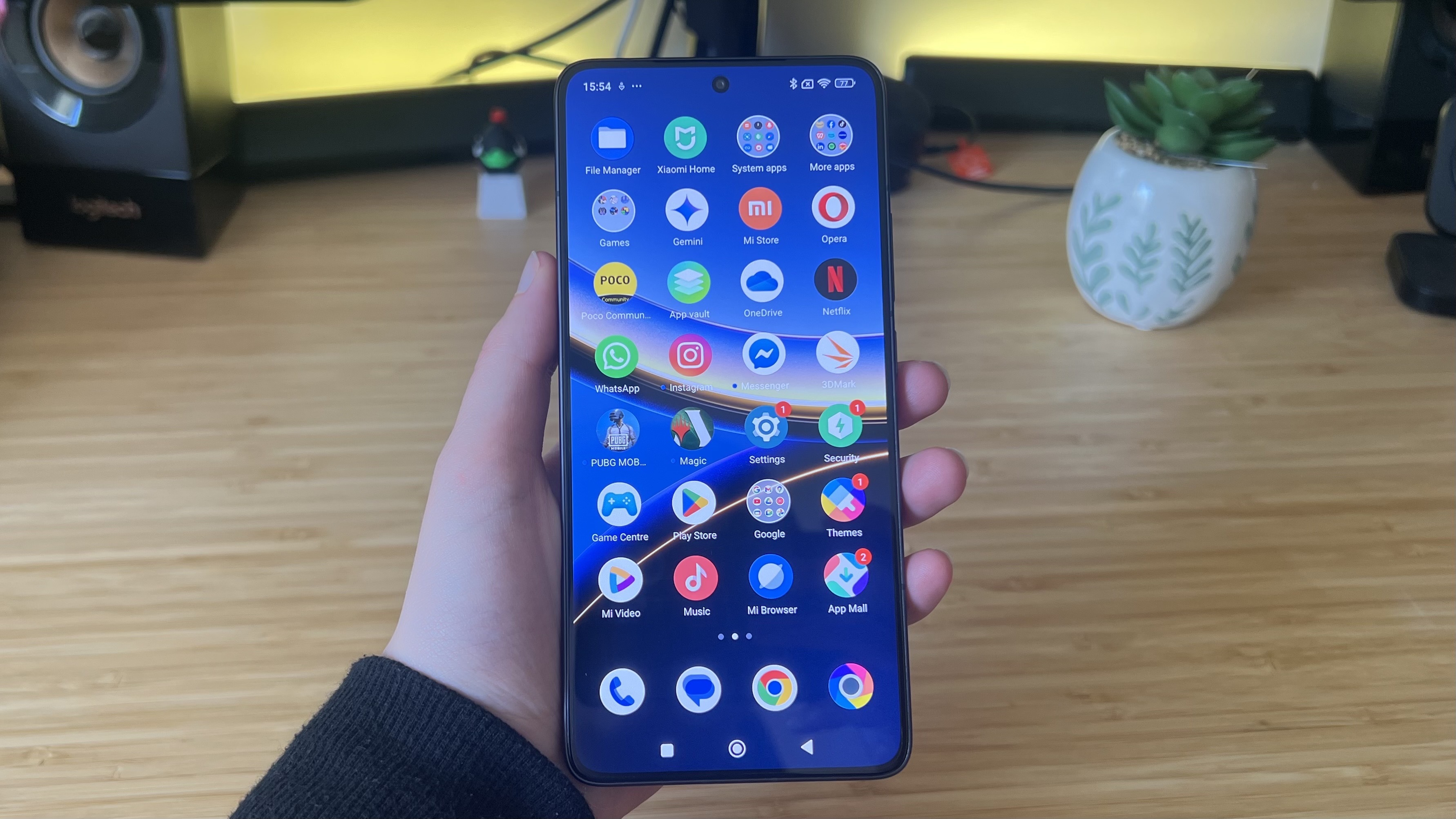 Poco F7 Pro in a reviewer's hand displaying icons on a home screen