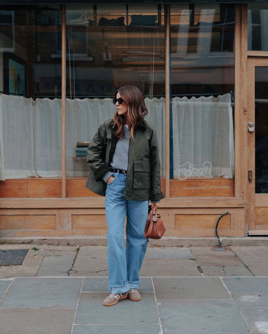kimturkington_ wears blue jeans, grey jumper, barn jacket and trainers