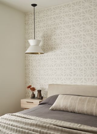 a guest bedroom wth a patterned wallpaper