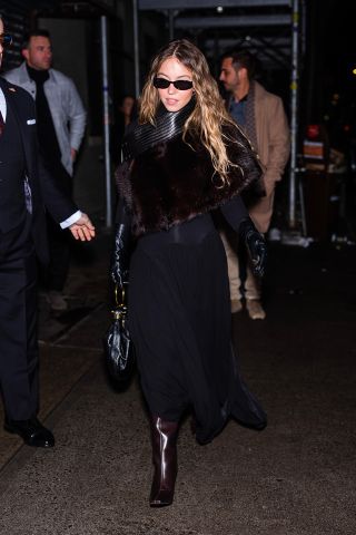 Sydney Sweeney In a long coat, boots, gloves and sunglasses out in Greenwich Village January 18.