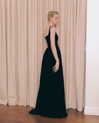 Elizabeth Debicki in front of a curtain