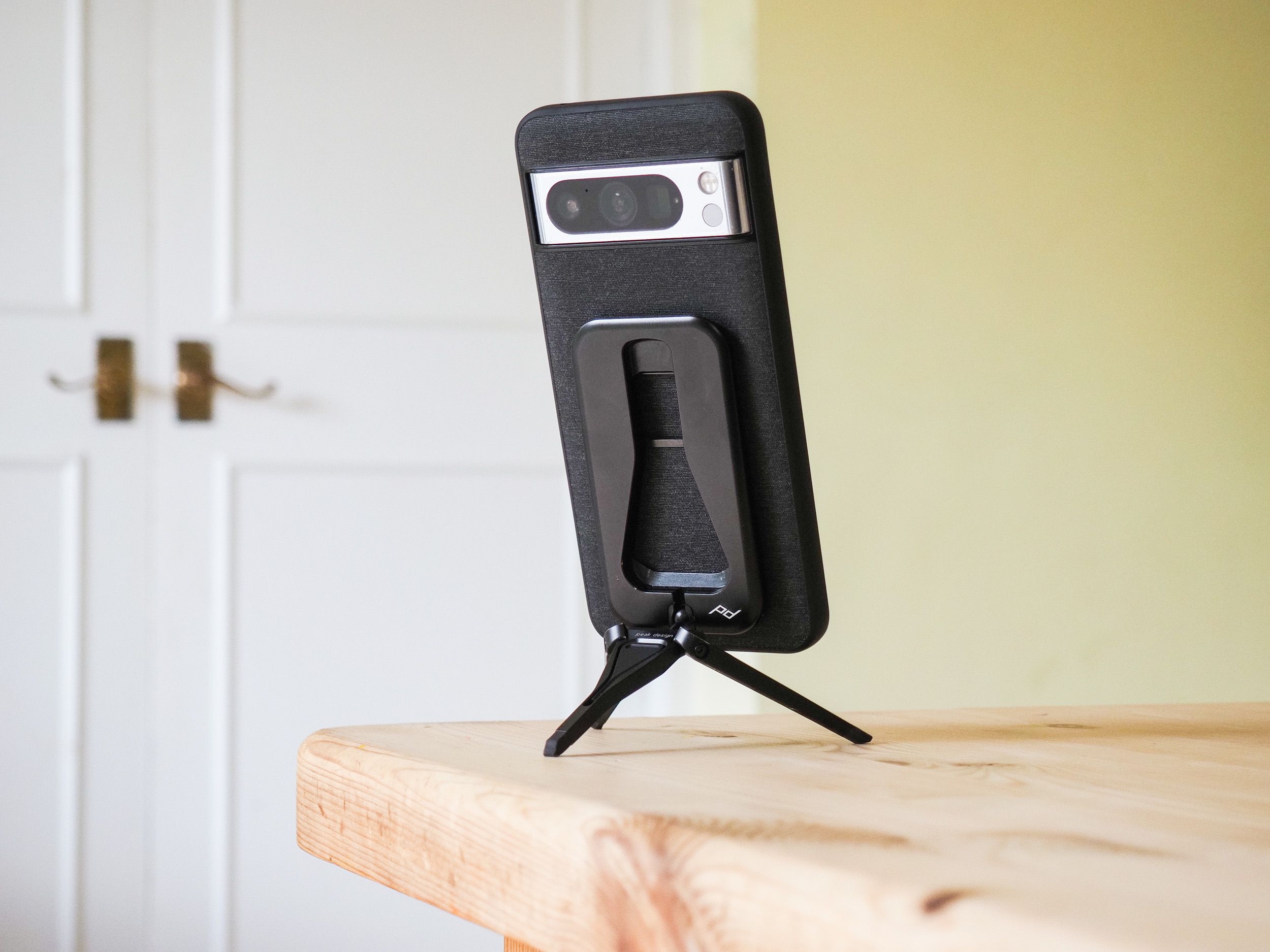 Peak Design Mobile Tripod folded away in use on a table, with a Pixel phone attached