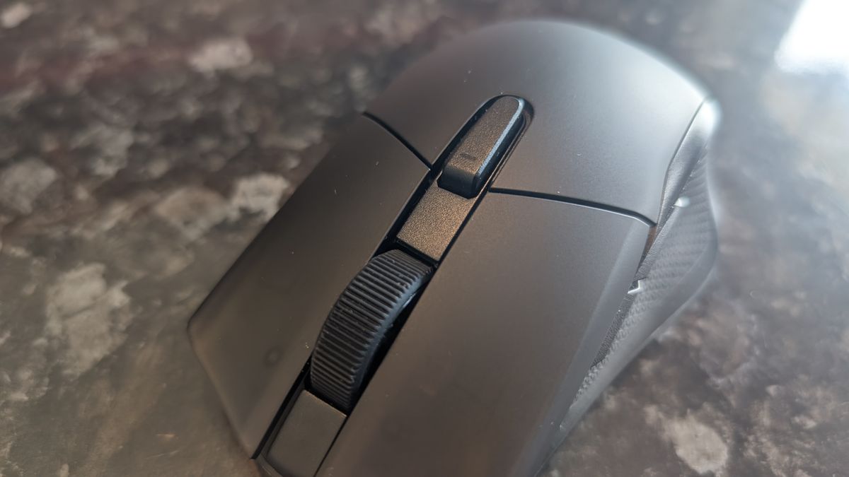 The Corsair Harpoon V2 Wireless gaming mouse pictured on a dark marble worktop.