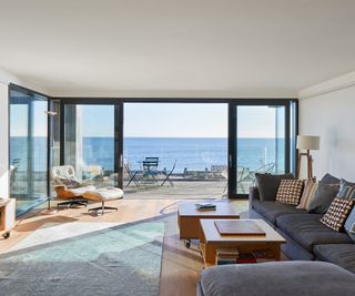 Sliding doors of triple clazing onto a terrace overlooking a sea view