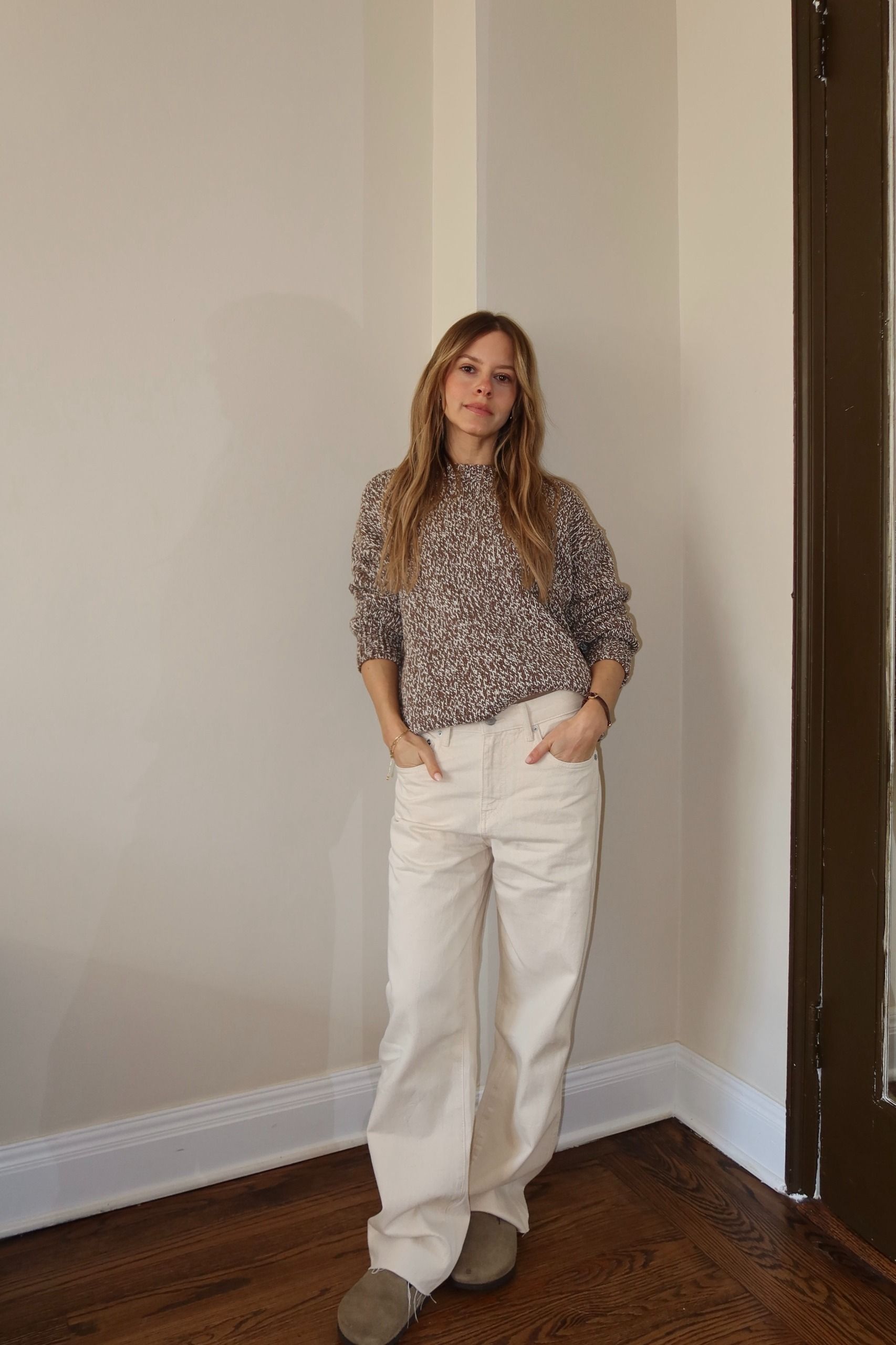 nikki wears a brown sweater, jenni kayne jeans and birkenstocks