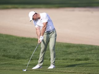 Rory McIlroy hitting an iron at impact with the golf ball