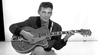 Duane Eddy, seated with one of his trademark Gretsch guitars