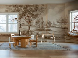 A neutral-colored playroom backed by a mural of trees