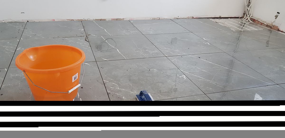 Tiling over underfloor heating retrofitted into a bathroom