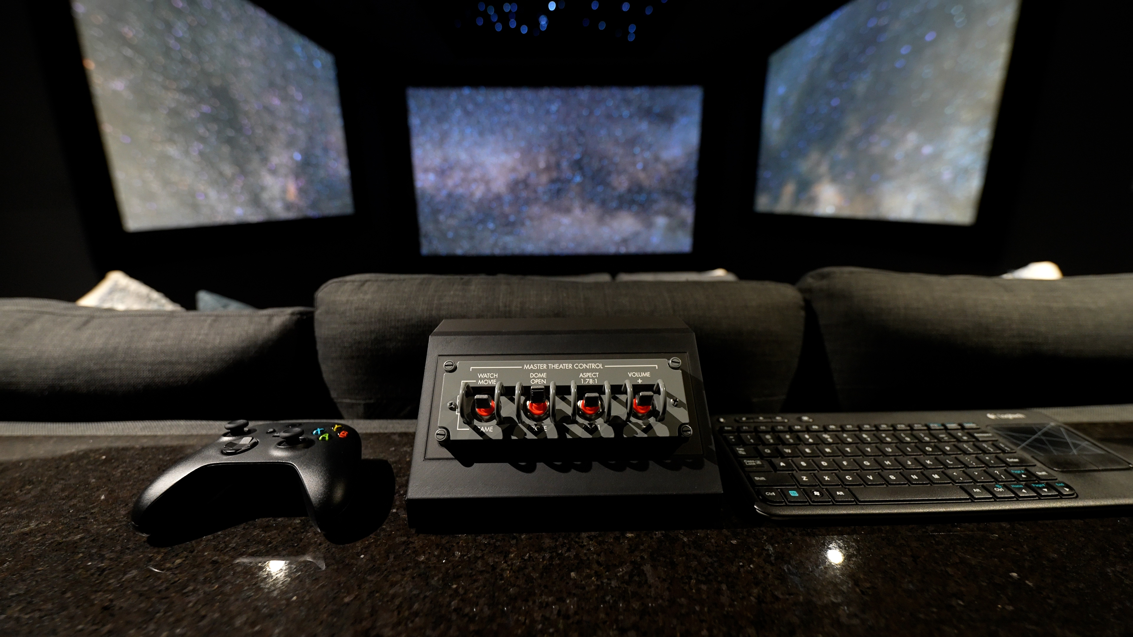images of The Ultimate Home Theater Gaming Setup theater showing three projection screens, sofas and gaming peripherals