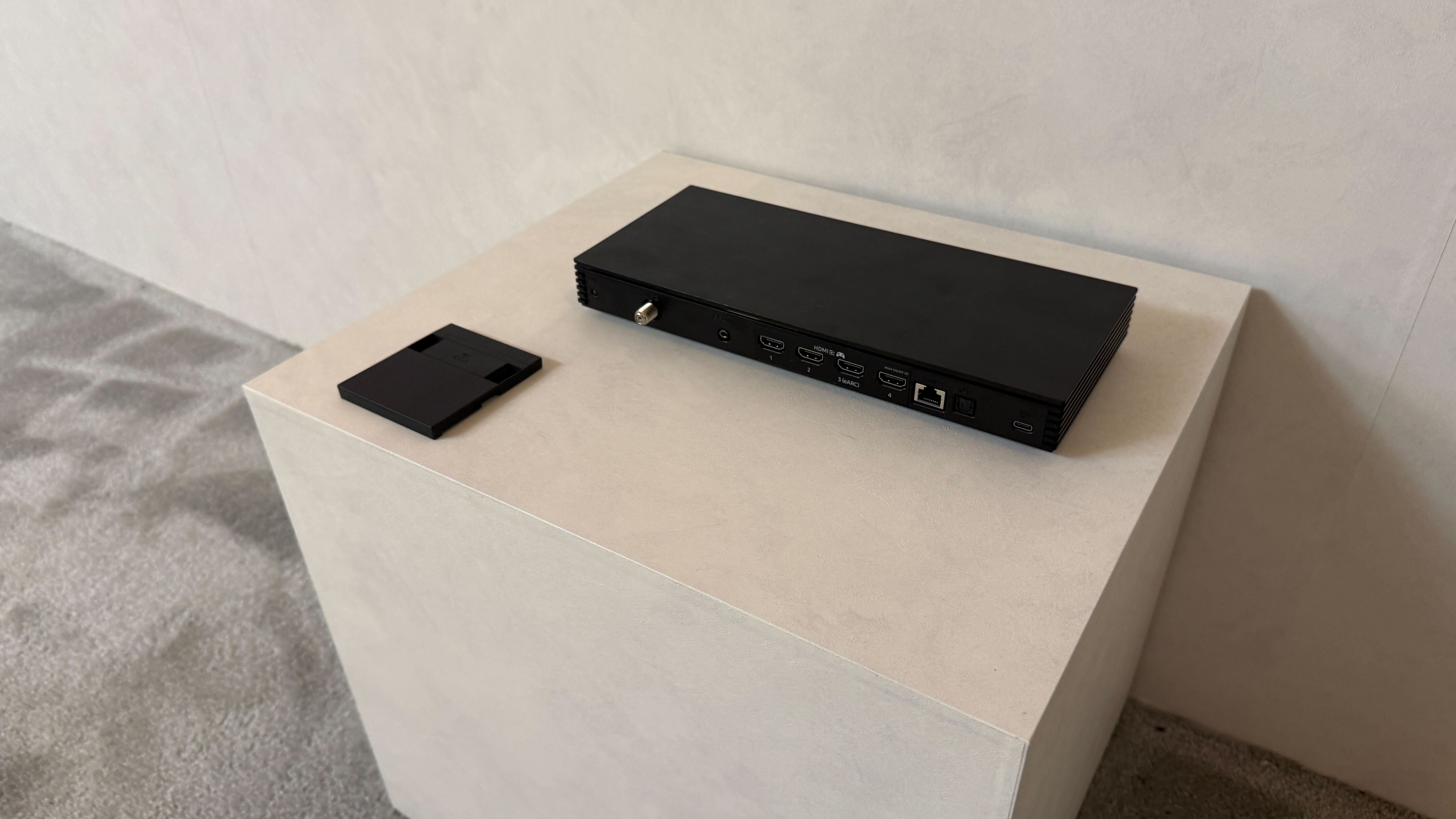 A wall mounted Samsung S95H showing stock footage of Las Vegas at night time