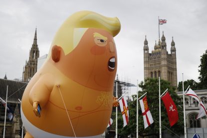 Anti-Trump protesters fly an orange baby balloon in Parliament Square.