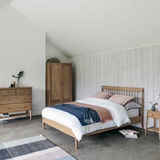 bedroom with white wall and wooden cupboard