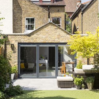 house exterior with brick walls and glass sliding doors