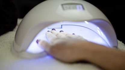 UV lamp at nail salon with hand inside