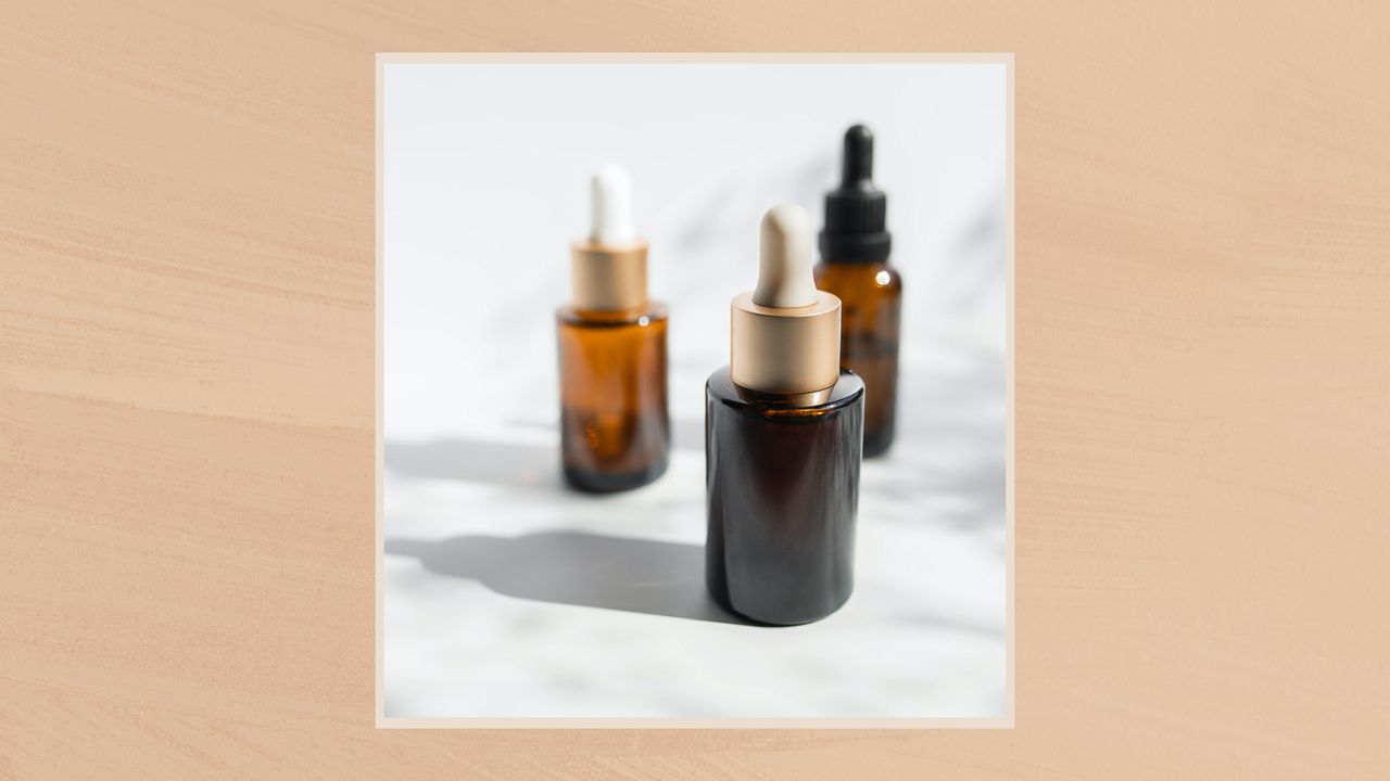 Image of a trio of serums in a pale beige frame set against a warm beige watercolour-style background