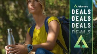 Woman hiking wearing Garmin Instinct watch