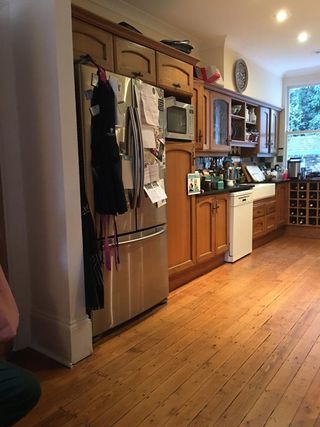kitchen before remodel, wooden floor, wood units, dated, cramped