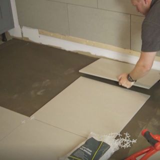 placing tiles for layout on floor
