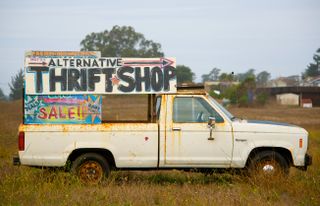 a truck advertsing a thrift shop