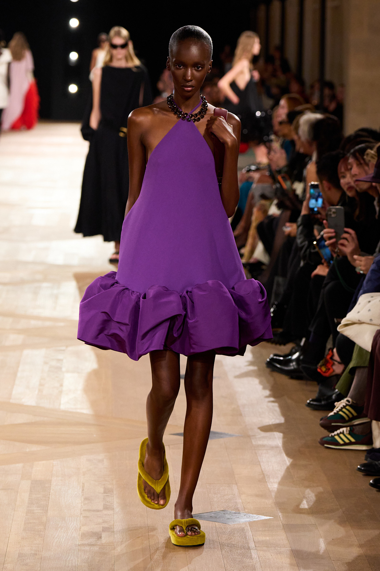 Model wears a purple dress with mustard flipflops on the Balenciaga spring/summer 2026 runway.