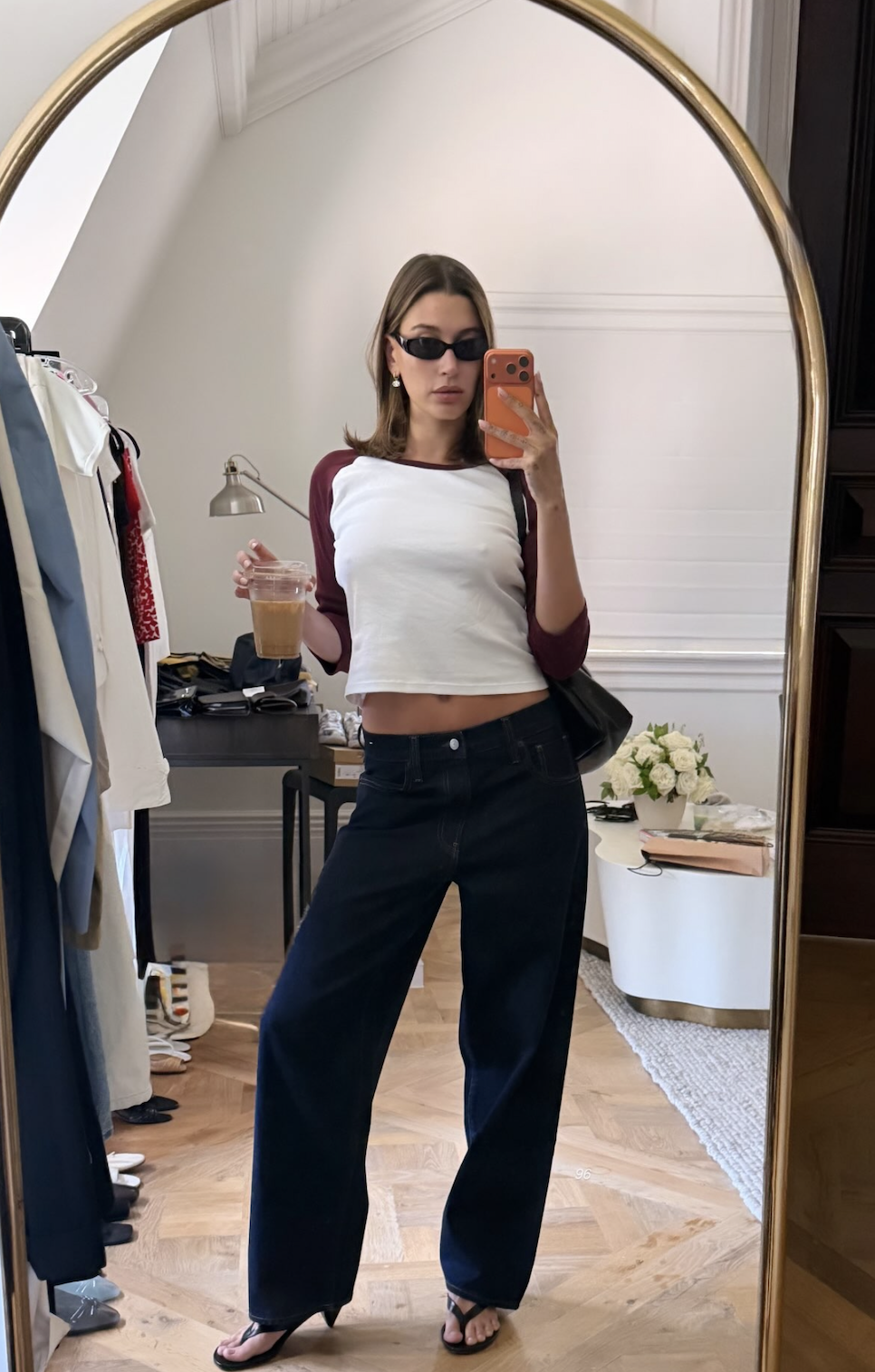 An image of hailey bieber wearing low rise jeans crop top outfit