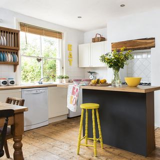 white kitchen with worktop and wooden flooring