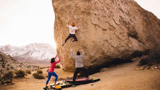 Three friends bouldering together in the desert