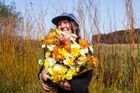 Floral designer Mackenzie Joyce holding a large bunch of flowers