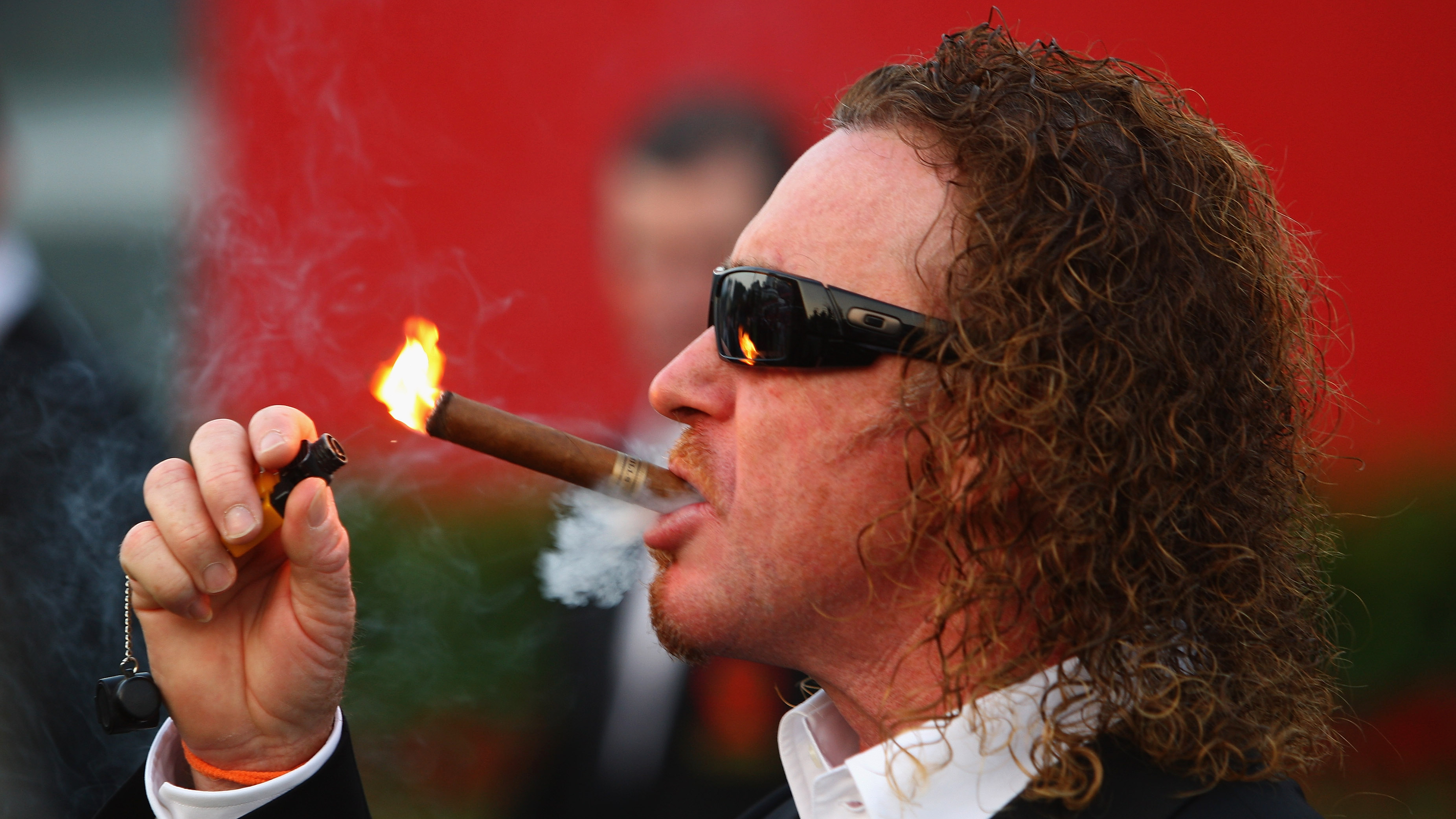 Miguel Angel Jimenez lighting a cigar