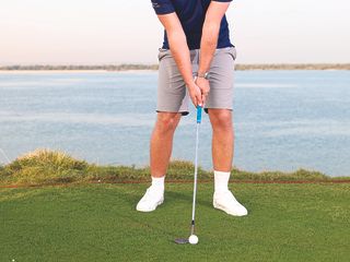 Golf Monthly Top 50 Coach Alex Buckner hitting a ball with a flop shot near the green